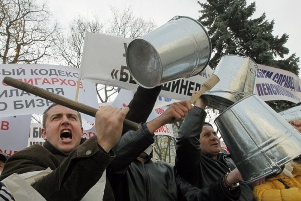 Дребни украински бизнесмени протестират с празни кофи пред парламента в столицата Киев. Те са против въвеждането на по-високи данъци, което по думите им ще разруши малкия бизнес в страната. Снимка: БГНЕС