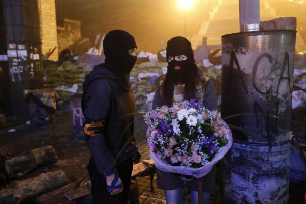 Активист, участващ в антиправителствените протести в Киев, подарява букет на приятелката си. Снимка: Reuters