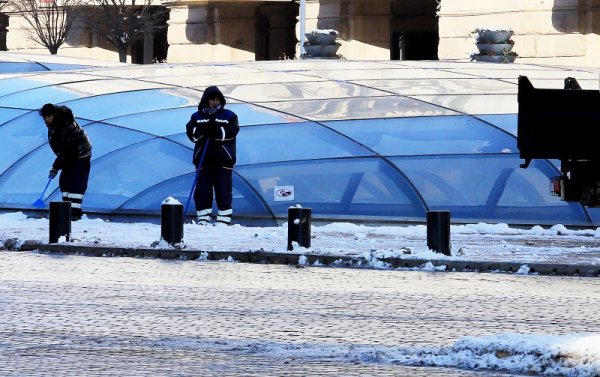 Служители на почистваща фирма събират и извозват натрупалия сняг от Ларгото. Снимка: БГНЕС