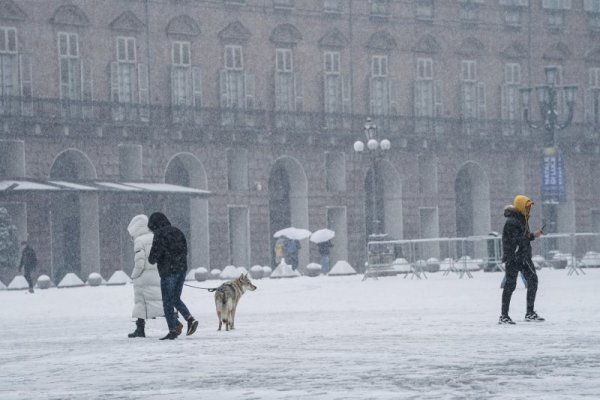 Пешеходци се разхождат сред падналия сняг в Торино, Италия. Снимка: БГНЕС
&nbsp;